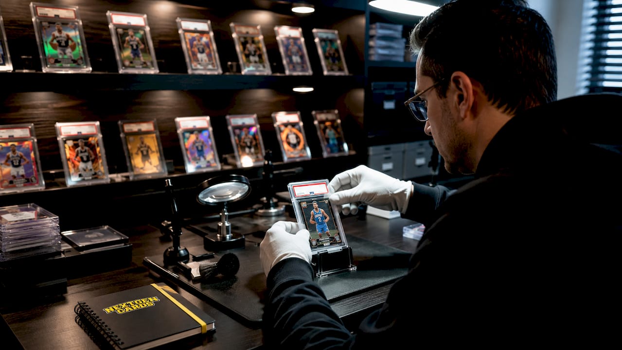 Gloved hand placing graded rookie card into protective case