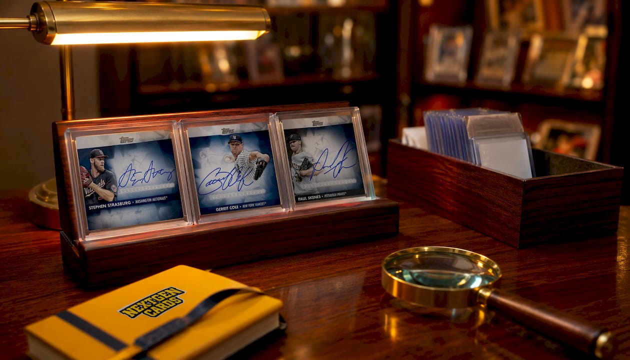 Premium sports trading cards on black surface with lighting